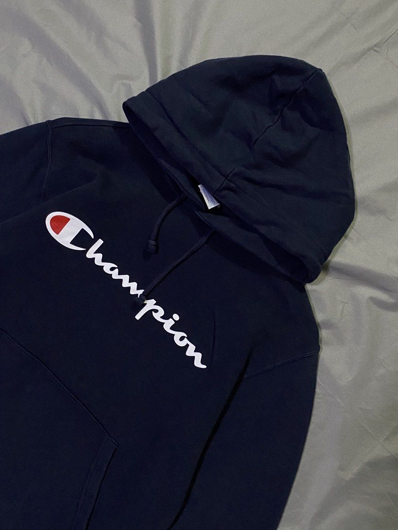 Champion Hoodie - Navy Blue - Medium (Category: Hoodies) located in Manila. Submitted by _thriftanddrip (Listing ID 1437238190, Image 2). Description: Medium Like new ₱399 +sf Navy blue Champion hoodie with the brand's logo on the front. It has a hood with drawstrings and a kangaroo pocket. The size is medium. The material composition is 100% cotton for the main body and 95% cotton, 5% polyurethane for the ribbing..