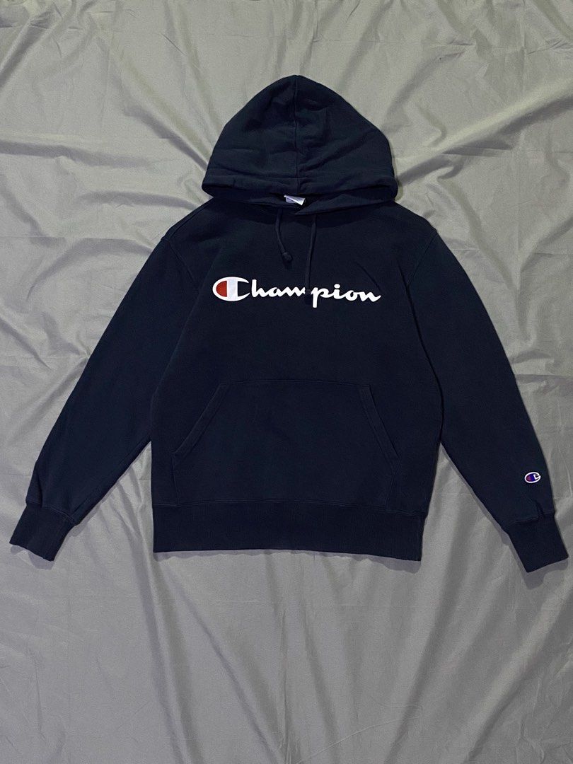 Champion Hoodie - Navy Blue - Medium (Category: Hoodies) located in Manila. Submitted by _thriftanddrip (Listing ID 1437238190, Image 1). Description: Medium Like new ₱399 +sf Navy blue Champion hoodie with the brand's logo on the front. It has a hood with drawstrings and a kangaroo pocket. The size is medium. The material composition is 100% cotton for the main body and 95% cotton, 5% polyurethane for the ribbing..