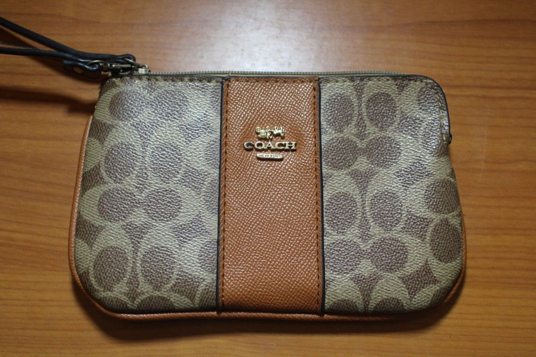 Coach Wristlet (Category: Purses & Pouches) located in Tarlac. Submitted by trishatrish3 (Listing ID 1437270228, Image 1). Description: Coach Corner Zip Wristlet in Signature Canvas with Stripe in Tan/Brown.
