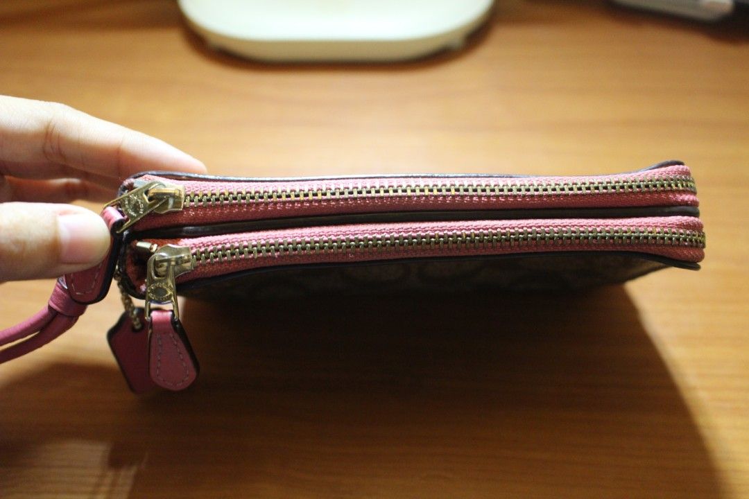 Coach Wristlet (Category: Purses & Pouches) located in Tarlac. Submitted by trishatrish3 (Listing ID 1437270559, Image 2). Description: Coach signature coated canvas double zip wristlet in brown and fuchsia.