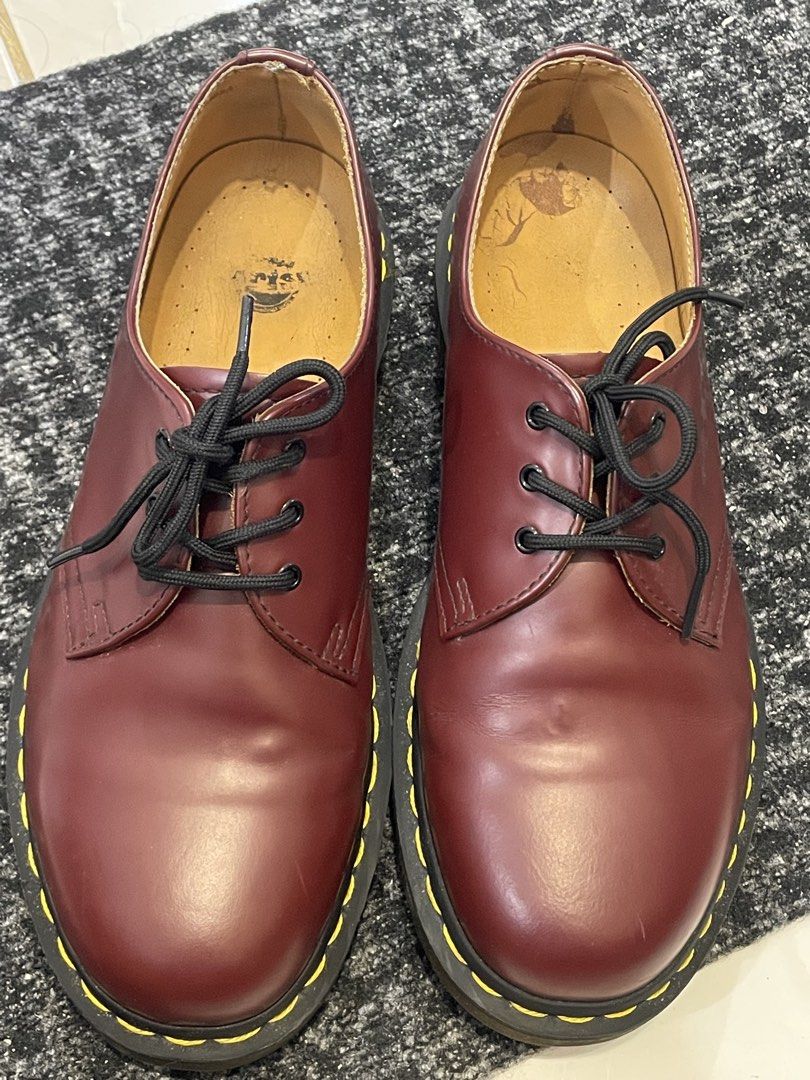 Dr. Martens 1461 Cherry Red (Category: Casual Shoes) located in Cainta. Submitted by jericot (Listing ID 1437251288, Image 1). Description: Classic Dr. Martens 1461 in cherry red. Features the iconic yellow stitching and a durable sole. The shoes have black laces and a leather upper. Visible wear on the insoles and some creasing on the leather. A timeless style for everyday wear. UK7/US8 MIC In good condition with no box Slight heel drags and cre