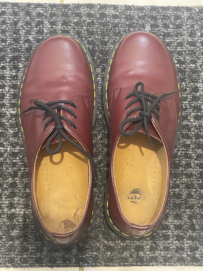 Dr. Martens 1461 Cherry Red (Category: Casual Shoes) located in Cainta. Submitted by jericot (Listing ID 1437251288, Image 2). Description: Classic Dr. Martens 1461 in cherry red. Features the iconic yellow stitching and a durable sole. The shoes have black laces and a leather upper. Visible wear on the insoles and some creasing on the leather. A timeless style for everyday wear. UK7/US8 MIC In good condition with no box Slight heel drags and cre