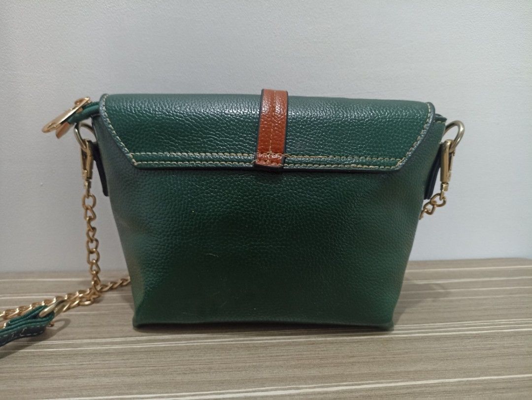 Emerald Green Mini Crossbody/Shoulder Bag (Category: Cross-body Bags) located in Cavite. Submitted by prncs.jc (Listing ID 1437326970, Image 3). Description: Product Description: - Item: Emerald Green Mini Crossbody/Shoulder Bag - Color: Deep Emerald Green with Tan Accents - Material: Textured Vegan Leather (Pebbled Finish) - Closure: Magnetic snap button on front flap with internal zipper for added security - Handle/Strap: Detachable gold-tone c