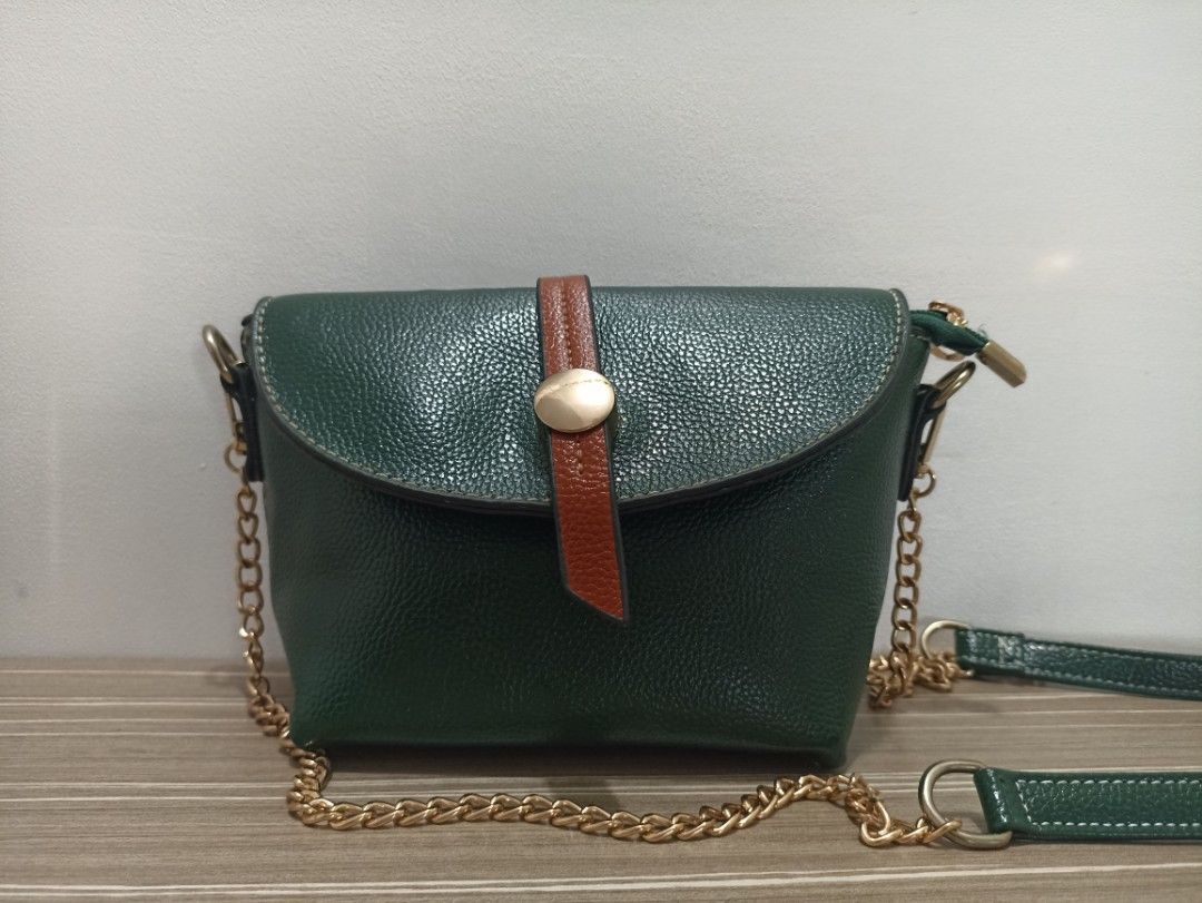 Emerald Green Mini Crossbody/Shoulder Bag (Category: Cross-body Bags) located in Cavite. Submitted by prncs.jc (Listing ID 1437326970, Image 1). Description: Product Description: - Item: Emerald Green Mini Crossbody/Shoulder Bag - Color: Deep Emerald Green with Tan Accents - Material: Textured Vegan Leather (Pebbled Finish) - Closure: Magnetic snap button on front flap with internal zipper for added security - Handle/Strap: Detachable gold-tone c