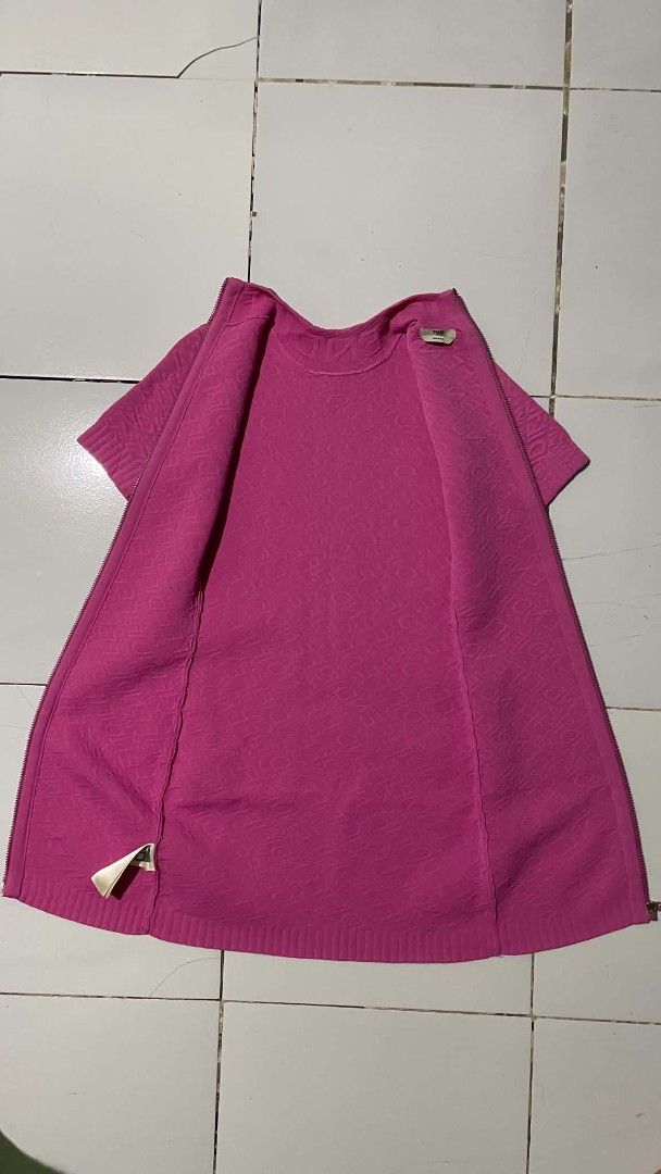 Fendi Pink Knit Dress (Category: Dresses) located in Barotac Nuevo. Submitted by gray101 (Listing ID 1437263542, Image 3). Description: - Fendi knit dress in vibrant pink. - Size: M - Style: Bodycon - Features: Textured pattern, short sleeves, and zip-up front. - Design: Mock neck. - Condition: Excellent, eye-catching piece..