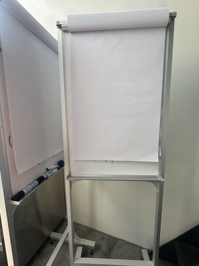 Flip Chart Stand with Rollers (Category: Other Mobile & Gadget Accessories) located in Singapore. Submitted by totally.tots (Listing ID 1437294792, Image 1). Description: (2 Feet x 3 Feet) Height 6 Feet- flip chart stand with rollers 1 pc - $55 2 pc - $95 - Silver frame - Features wheels for easy movement - Perfect for presentations, meetings, and brainstorming.