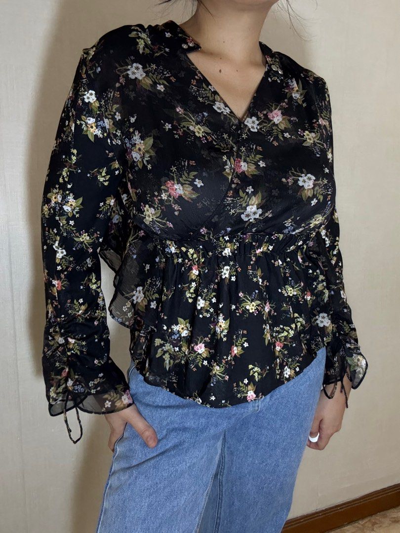 Floral Print Long Sleeve Blouse (Category: Blouses) located in Davao. Submitted by spanish.lattefor1 (Listing ID 1437267305, Image 1). Description: - Black base with vibrant floral print - Long sleeves with ruched cuffs - Flattering V-neckline - Elastic waist for a cinched silhouette - Made of lightweight, possibly sheer fabric.