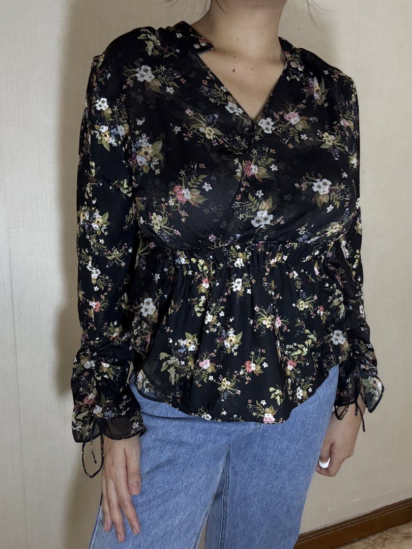 Floral Print Long Sleeve Blouse (Category: Blouses) located in Davao. Submitted by spanish.lattefor1 (Listing ID 1437267305, Image 2). Description: - Black base with vibrant floral print - Long sleeves with ruched cuffs - Flattering V-neckline - Elastic waist for a cinched silhouette - Made of lightweight, possibly sheer fabric.