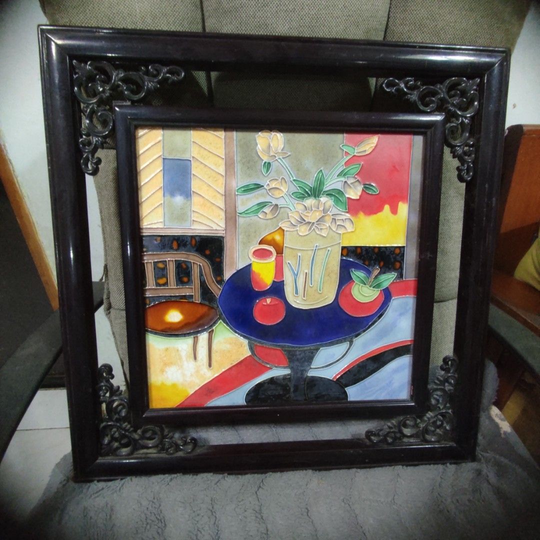Framed Ceramic Tile Art (Category: Wall Decor) located in Las Pinas. Submitted by lawki_stuff (Listing ID 1437214743, Image 3). Description: - Framed ceramic tile artwork - Depicts a vase of flowers and abstract elements - Dark-colored frame with decorative corner accents - Square-shaped - Size 18" x 18".