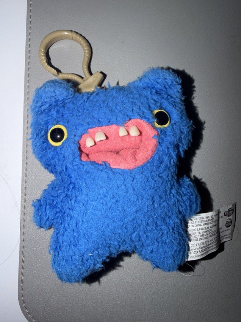FUGGLER KEYCHAINS (Category: Plushies & Soft Toys) located in Singapore. Submitted by maltegan248 (Listing ID 1437338478, Image 1). Description: - Adorable Uglydolls plushie keychains - Available in blue and white - Features a convenient clip for easy attachment - Perfect for keys, bags, or backpacks - Great for collectors - Makes a unique gift ONE FOR 10 TWO FOR 18,16 only if fast deal by (self collect/meetup at convi).