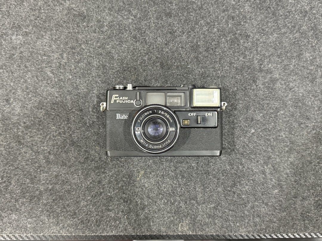 Fujica Flash Date Camera (Category: Cameras) located in Manila. Submitted by qygn94zbr737519 (Listing ID 1437324061, Image 1). Description: - Fujica Flash Date camera - Fujinon 1:2.8/38mm lens - Built-in flash with on/off switch - Date function - Black camera body - Silver lens ring.