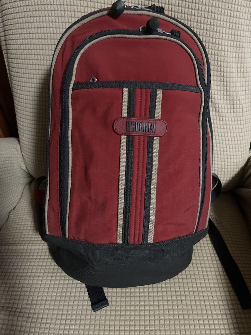 Hedgren Red Backpack (Category: Backpacks) located in Manila. Submitted by rlyt007 (Listing ID 1437316656, Image 1). Description: - Hedgren backpack in a striking red and gray color scheme. - Main compartment with zippered and internal pockets. - Comfortable padded back panel and shoulder straps. - Includes a top handle and adjustable shoulder straps. - Features the Hedgren logo..