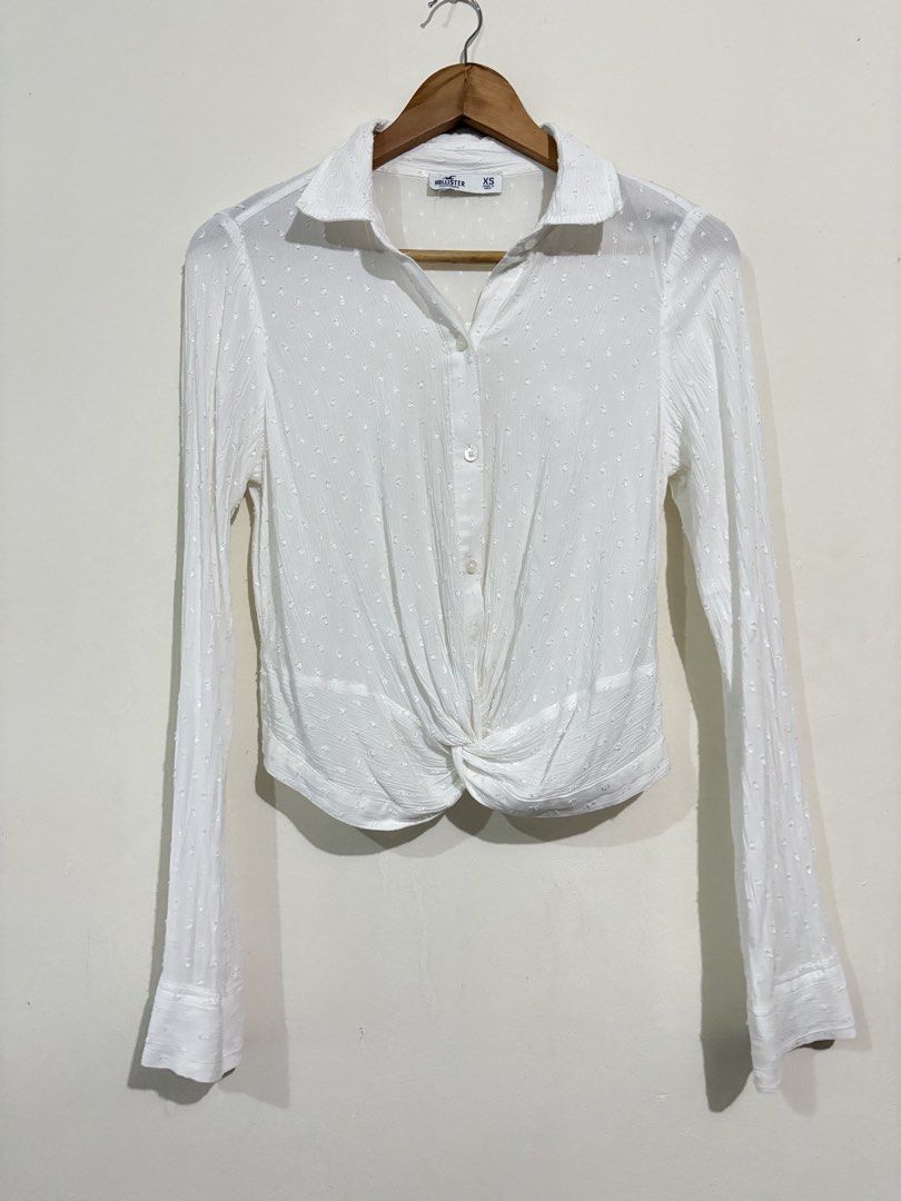Hollister Twisted Front Button Down Shirt (Category: Blouses) located in Pasig City. Submitted by shopsmart.mnl (Listing ID 1437396457, Image 2). Description: Very nice in actual and no issue or discoloration Pit to pit 18” W 16” laid flat.