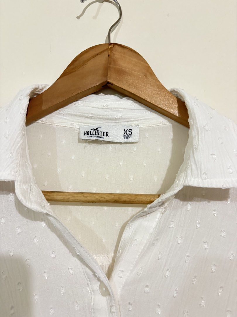 Hollister Twisted Front Button Down Shirt (Category: Blouses) located in Pasig City. Submitted by shopsmart.mnl (Listing ID 1437396457, Image 3). Description: Very nice in actual and no issue or discoloration Pit to pit 18” W 16” laid flat.