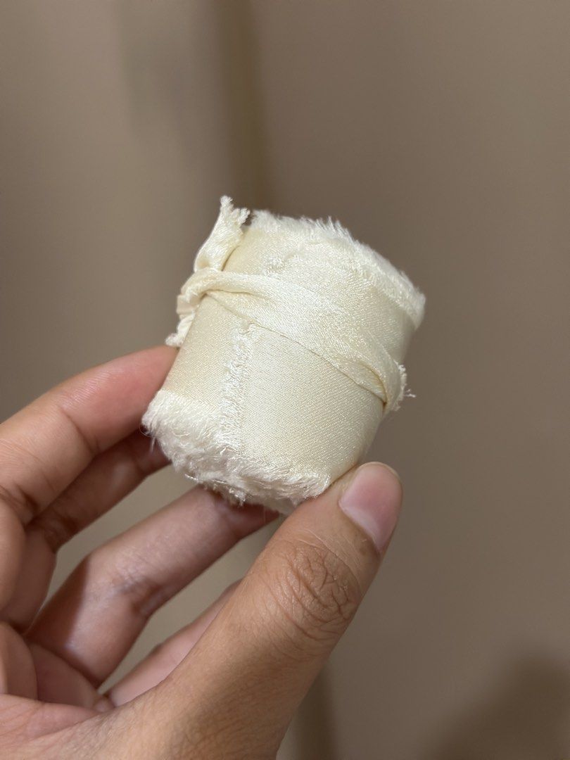 Ivory/Cream Silk Ribbon (Category: Craft Supplies & Tools) located in Malabon City. Submitted by yanyanpreloved (Listing ID 1437325306, Image 2). Description: - 5 pcs. ‼️5 pcs‼️Ivory silk ribbon - Ideal for crafts and gift wrapping - Adds an elegant touch - Features a soft, slightly frayed edge - Creamy ivory color - Each roll individually wrapped New! RFS: Extra.