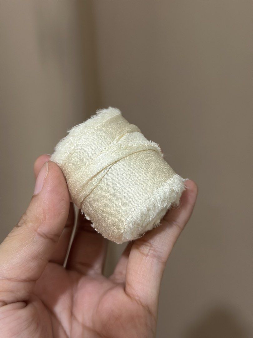 Ivory/Cream Silk Ribbon (Category: Craft Supplies & Tools) located in Malabon City. Submitted by yanyanpreloved (Listing ID 1437325306, Image 1). Description: - 5 pcs. ‼️5 pcs‼️Ivory silk ribbon - Ideal for crafts and gift wrapping - Adds an elegant touch - Features a soft, slightly frayed edge - Creamy ivory color - Each roll individually wrapped New! RFS: Extra.