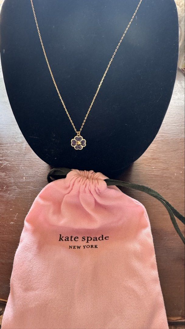 Kate Spade Flower Pendant Necklace (Category: Necklaces) located in Santa Cruz. Submitted by maqui15 (Listing ID 1437397958, Image 1). Description: - Kate Spade necklace - Delicate gold chain - Flower pendant with black enamel and gold border - Features a small gem in the center - Adjustable length - Spade charm near the clasp - Includes Kate Spade dust bag.