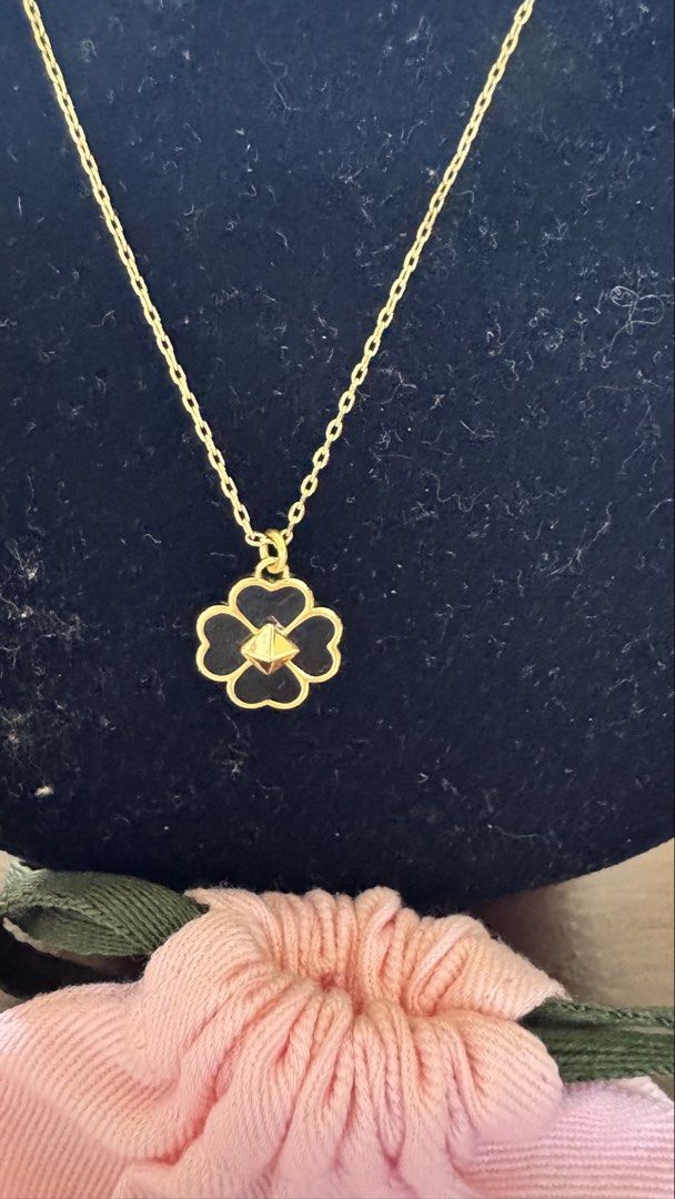 Kate Spade Flower Pendant Necklace (Category: Necklaces) located in Santa Cruz. Submitted by maqui15 (Listing ID 1437397958, Image 3). Description: - Kate Spade necklace - Delicate gold chain - Flower pendant with black enamel and gold border - Features a small gem in the center - Adjustable length - Spade charm near the clasp - Includes Kate Spade dust bag.