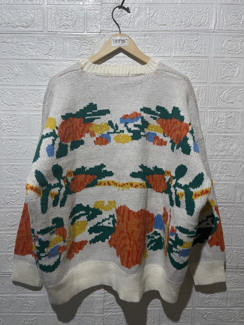 KNITTED SWEATER (Category: Coats, Jackets and Outerwear) located in Quezon City. Submitted by davidso682 (Listing ID 1437361347, Image 3). Description: - Cream-colored sweater - Features a floral design - Round neckline and long sleeves - Made in Korea - Floral pattern includes orange, yellow, green, and blue colors - Ribbed hem and cuffs.