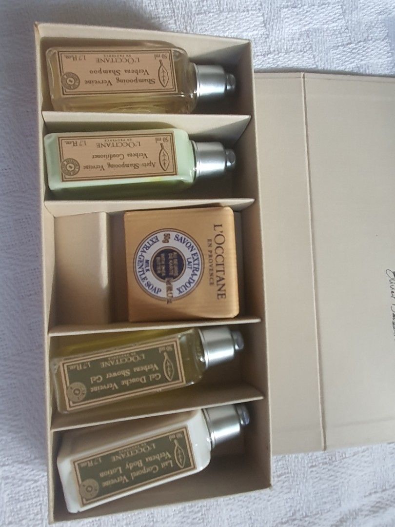 L'Occitane En Provence Verbena Gift Set (Category: Body Care) located in Iloilo. Submitted by bricknoir (Listing ID 1437213823, Image 2). Description: - L'Occitane Verbena Gift Set - Includes travel-sized shampoo, conditioner, body lotion, shower gel, and a shea butter soap. - Comes in a branded box with an elastic band. - Features a quote from Olivier Baussan..