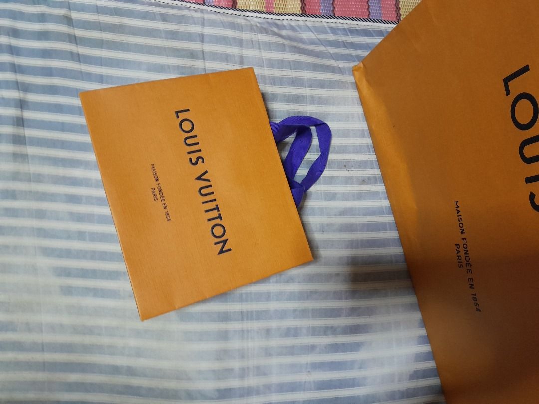 Louis Vuitton Shopping Bag - XS (Category: Luxury Bags & Wallets) located in Caloocan City. Submitted by josh.m138 (Listing ID 1437363711, Image 1). Description: - Authentic Louis Vuitton shopping bag - Includes orange shopping bags with blue handles - Features the Louis Vuitton logo - Ideal for gifting or collecting.