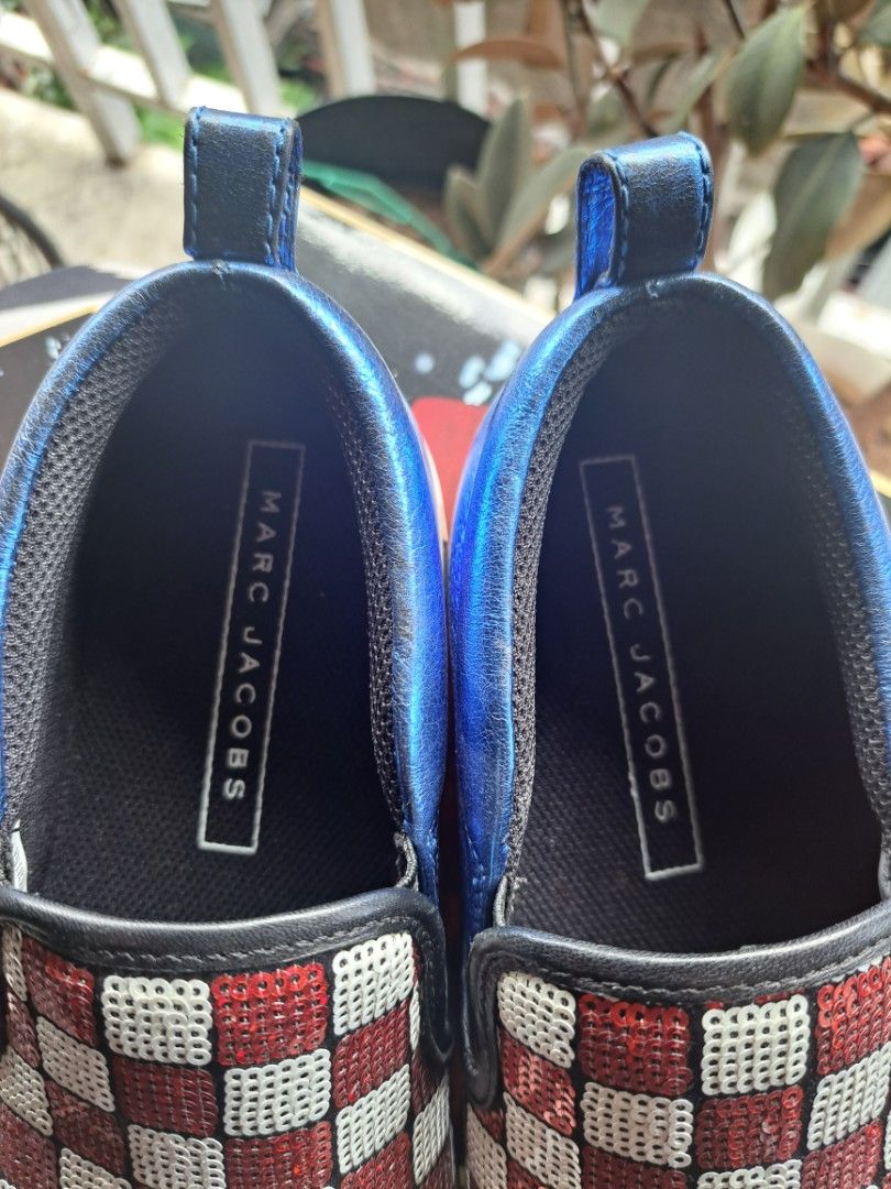 Marc Jacobs Checkerboard Slip-on Shoes (Category: Sneakers) located in Makati City. Submitted by arjay1026 (Listing ID 1437260279, Image 3). Description: - Marc Jacobs slip-on shoes - Unique checkerboard design - Blue metallic trim and pull tab - White soles with Marc Jacobs logo - Size: 37 - Perfect for adding flair to your outfit -Good as new.