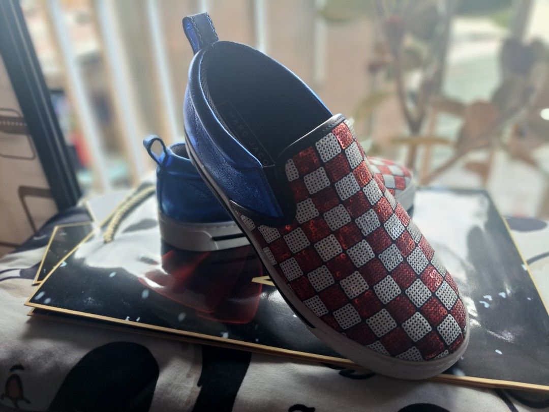 Marc Jacobs Checkerboard Slip-on Shoes (Category: Sneakers) located in Makati City. Submitted by arjay1026 (Listing ID 1437260279, Image 2). Description: - Marc Jacobs slip-on shoes - Unique checkerboard design - Blue metallic trim and pull tab - White soles with Marc Jacobs logo - Size: 37 - Perfect for adding flair to your outfit -Good as new.