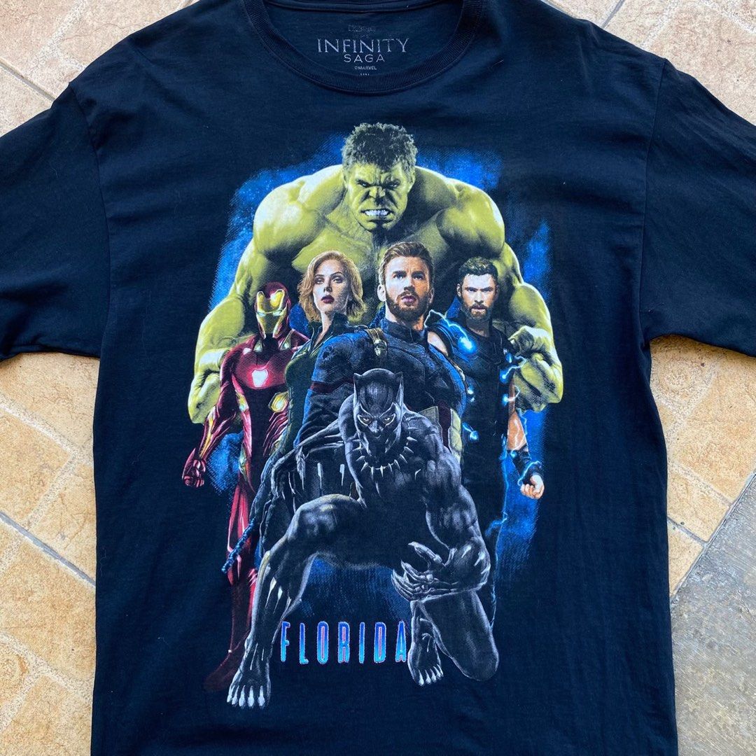 Marvel Avengers Infinity Saga T-shirt (Category: Tshirts & Polo Shirts ) located in Manila. Submitted by hakeemmmmm (Listing ID 1437285650, Image 2). Description: - Black Avengers t-shirt - Features Iron Man, Black Widow, Captain America, Thor, Hulk, and Black Panther graphic - Includes "FLORIDA" print - "INFINITY SAGA" logo on collar - Crew neck.