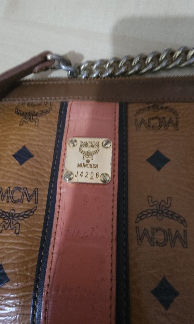 MCM Visetos Chain Clutch Bag (Category: Luxury Bags & Wallets) located in Batangas. Submitted by finestonesandfindsph (Listing ID 1437317225, Image 2). Description: - MCM Visetos chain clutch bag - Iconic MCM logo print with a pink stripe - Gold-tone metal logo plate - Perfect for everyday or special events.