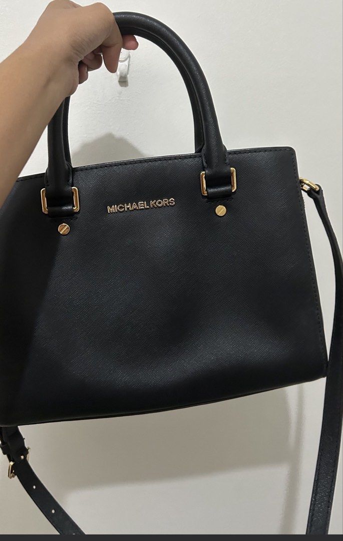 Michael Kors Black Handbag with Shoulder Strap (Category: Luxury Bags & Wallets) located in Marikina City. Submitted by kimv31 (Listing ID 1437315380, Image 2). Description: - Black Michael Kors handbag - Gold-toned hardware - Top handle and detachable shoulder strap - Interior zip closure - Interior strap with clasp - Michael Kors logo visible - Smooth material.