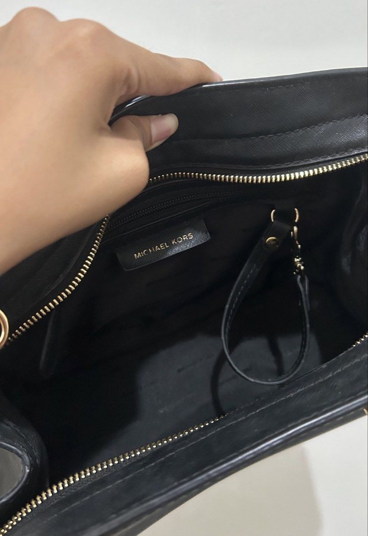 Michael Kors Black Handbag with Shoulder Strap (Category: Luxury Bags & Wallets) located in Marikina City. Submitted by kimv31 (Listing ID 1437315380, Image 1). Description: - Black Michael Kors handbag - Gold-toned hardware - Top handle and detachable shoulder strap - Interior zip closure - Interior strap with clasp - Michael Kors logo visible - Smooth material.