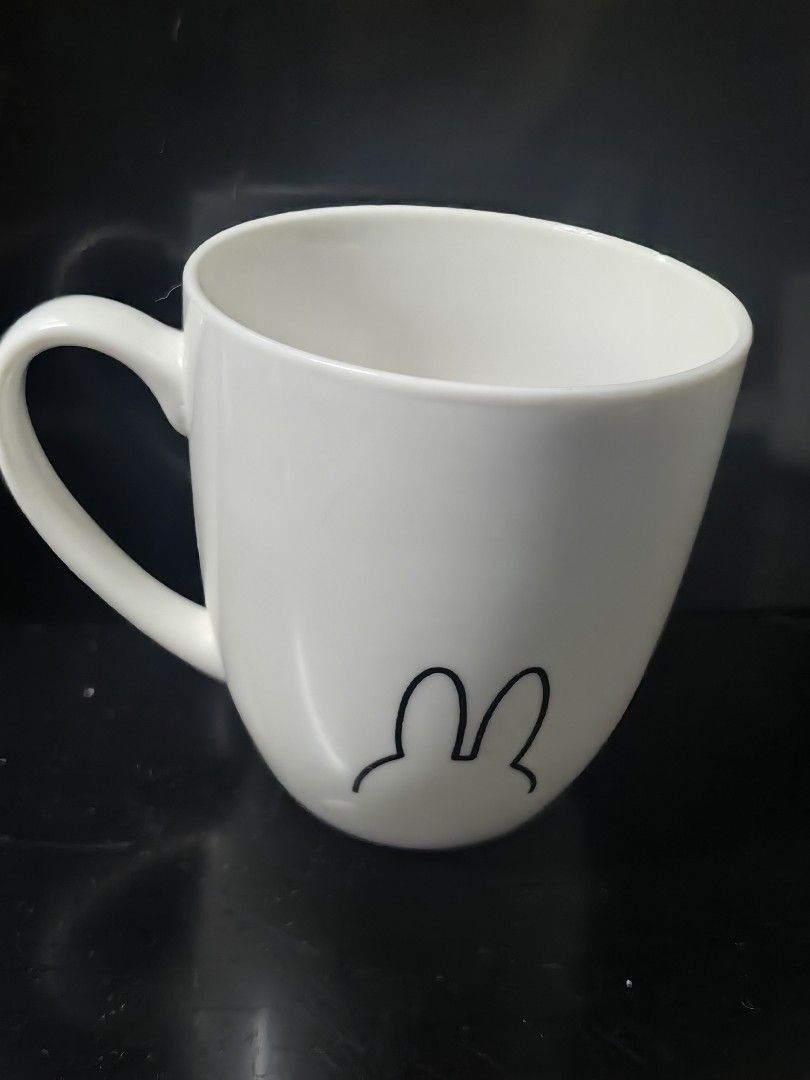 Miffy 65th Anniversary Mug (Category: Coffee & Tea Tableware) located in Rizal. Submitted by gkstcenit (Listing ID 1437297826, Image 2). Description: - Miffy design mug - Features a bunny outline and full Miffy illustration - Includes a handle and curved shape - Lawson collaboration - Approximately 4 inches tall.