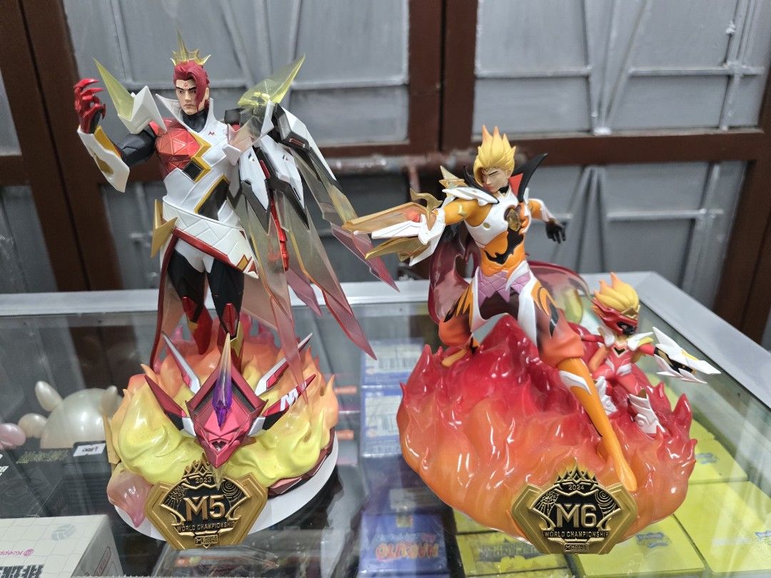 Mobile Legends M5 & M6 Champion Figurines (Category: Figurines & Statues) located in Santa Rosa. Submitted by dlsud0708 (Listing ID 1437364318, Image 1). Description: - Mobile Legends collectible figurines. - Includes two figurines. - Color schemes: Red/White and Yellow/Orange. - Mounted on flame-like bases. - Features "M5" and "M6" champion logos. - Detailed and well-crafted..