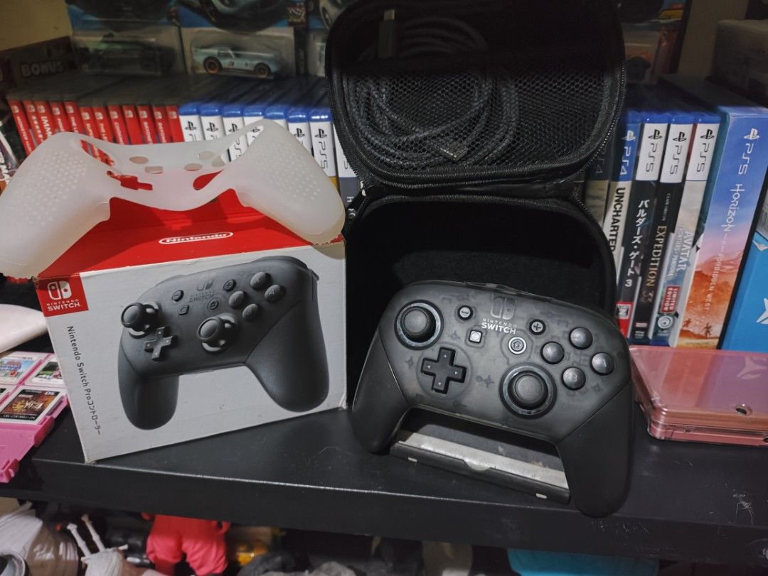 Nintendo Switch Pro Controller (Category: Controllers) located in Manila. Submitted by kobecruz923 (Listing ID 1437335173, Image 1). Description: - Nintendo Switch Pro Controller - Color: Black - Includes: - Original Box - Carrying Case (Black) - Silicone Cover (White) - Charging Cable.
