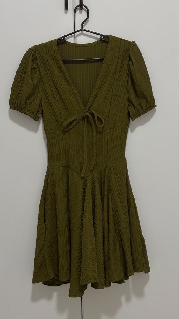 Olive Green Textured Dress (Category: Dresses) located in Munoz. Submitted by matilda. (Listing ID 1437392357, Image 1). Description: - Olive green dress - Textured fabric - V-neckline with tie - Short puff sleeves - Fitted waist - Flared skirt - Stylish and comfortable.
