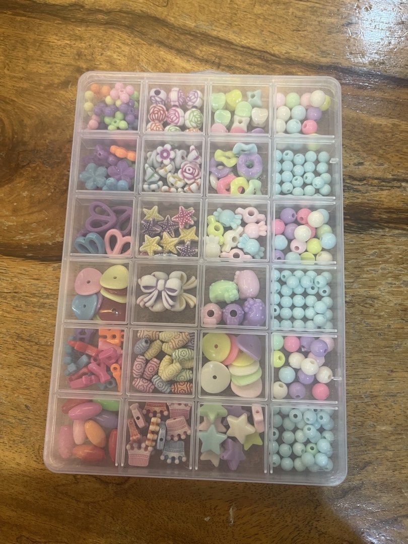Pastel Beads Assortment in Organizer (Category: Craft Supplies & Tools) located in Mandaluyong City. Submitted by manilasyoungstunna (Listing ID 1437255876, Image 2). Description: RFS: declutterring Delightful assortment of pastel-colored beads in a clear organizer. Includes various shapes and sizes, such as round beads, star shapes, flowers, and other decorative elements. Perfect for crafting jewelry, accessories, or other DIY projects. The orga
