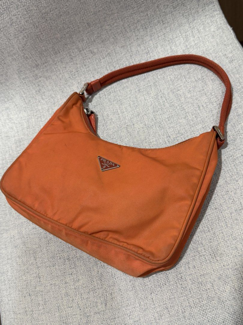 Prada Orange Nylon Bag (Category: Luxury Bags & Wallets) located in San Juan City. Submitted by girlmaths (Listing ID 1437301041, Image 2). Description: - bought from trusted vintage shop: @bagnginamo - Condition: well used - few dirt marks but can be washed. This was sent to a bag spa, inner lining was re-stitched, and bag was cleaned. - RFS: decluttering - Price negotiable .