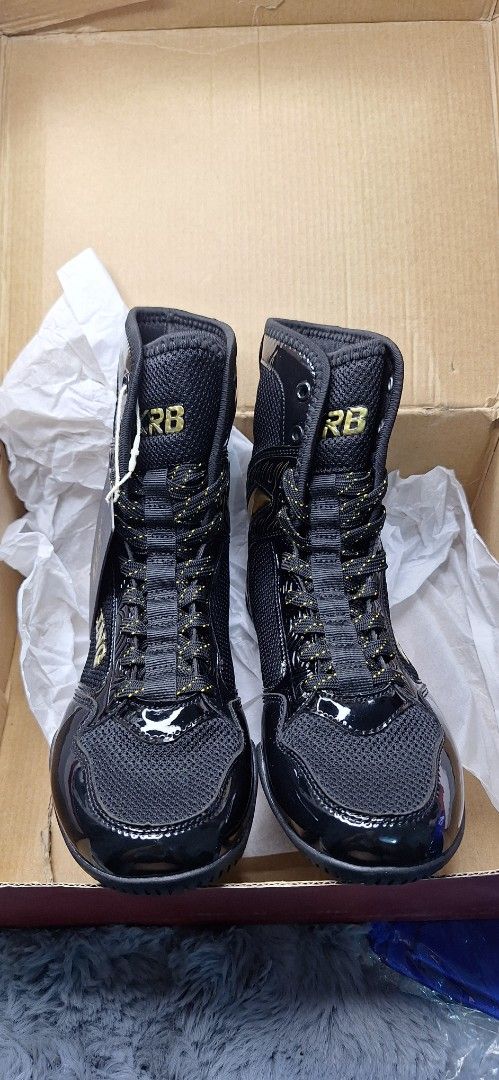 RB Boxing Shoes Black size 37 (Category: Combat Sports) located in Manila. Submitted by chavezmade78698 (Listing ID 1437365116, Image 2). Description: - Black boxing shoes with gold accents - Features "RB" brand logo - "BOXING" text visible on the side - Shiny, patent leather-like toe and heel - Includes original box and tissue paper.
