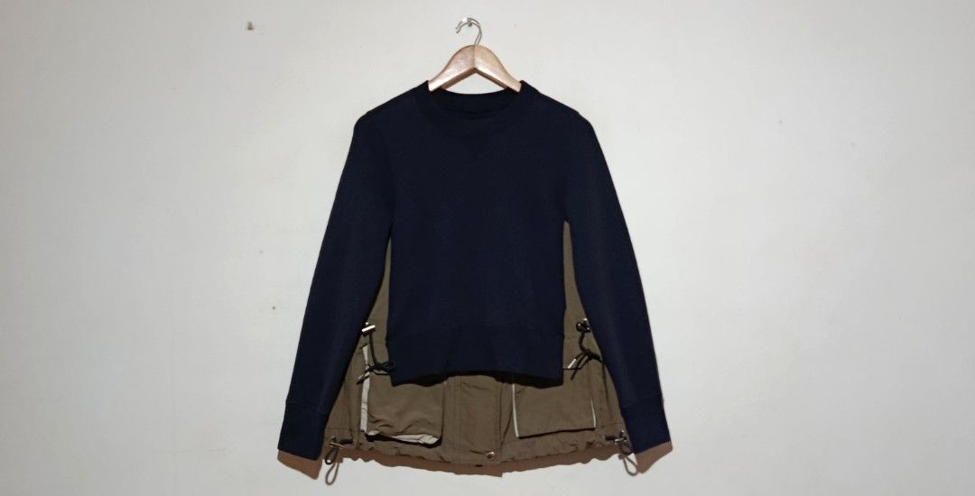Sacai - Docking Sweatshirt Utility Drawstring - Navy Blue/Khaki (Category: Coats, Jackets and Outerwear) located in San Fernando. Submitted by son.twice.stuff (Listing ID 1437357156, Image 1). Description: Item: Sacai - Docking Sweatshirt Utility Drawstring - Navy Blue/Khaki Tagged Size: 1 Fit Medium Dimensions Length: 26" Width: 18" Shoulder: 15" Sleeve: 24" Condition: Excellent Zipper: YKk VISLON Puller: SACAI Made in Japan Material 62% Cotton 