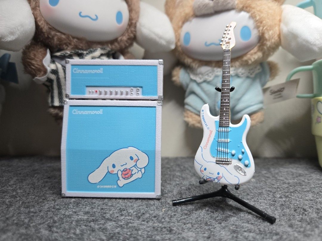 Sanrio Cinnamoroll Guitar and Amplifier Set (mini figures) (Category: Musical Instruments) located in Manila. Submitted by joycee03 (Listing ID 1437240778, Image 2). Description: - Cinnamoroll guitar and amplifier set - Features a blue and white design with Cinnamoroll graphics - Includes matching amplifier and guitar stand - Sanrio logo present - Ideal for collectors and Sanrio enthusiasts.