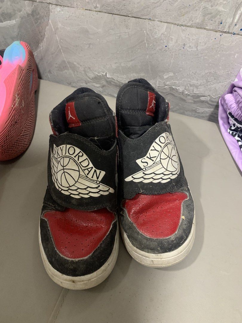Sky Jordan 1 High Top Sneakers (Category: Sneakers) located in Manila. Submitted by angeloujos65502 (Listing ID 1437352554, Image 2). Description: - Sky Jordan 1 high-top sneakers - Color: Black and Red - Size: US 3Y - Features a velcro strap with Sky Jordan logo - White sole - Manufacturing date: 08/19/19.