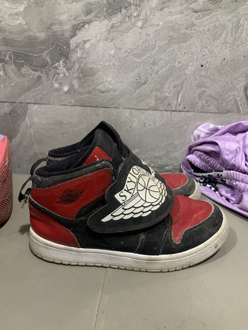 Sky Jordan 1 High Top Sneakers (Category: Sneakers) located in Manila. Submitted by angeloujos65502 (Listing ID 1437352554, Image 3). Description: - Sky Jordan 1 high-top sneakers - Color: Black and Red - Size: US 3Y - Features a velcro strap with Sky Jordan logo - White sole - Manufacturing date: 08/19/19.