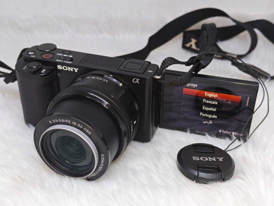 Sony Alpha ZV-E10 4K Camera (Category: Cameras) located in Manila. Submitted by ultimogizmos (Listing ID 1437382144, Image 3). Description: - Sony Alpha ZV-E10 4K camera - Includes lens (E 3.5-5.6/PZ 16-50 OSS), charger, and camera bag - Comes with a camera strap - Features a flip-out screen - Offers various shooting modes - Color: Black The Sony ZV-E10 is a 24MP APS-C mirrorless interchangeable lens camera aimed at vloggers. It features an artic