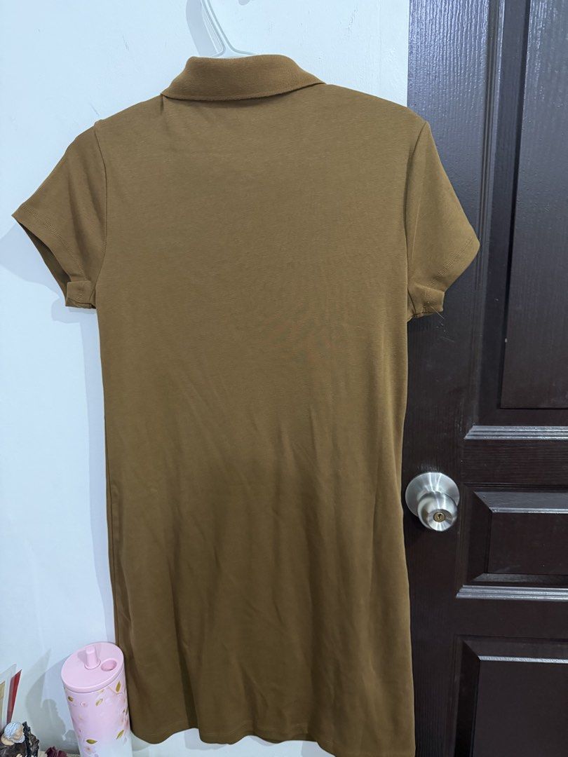 Tommy Hilfiger Polo Dress (Category: Dresses) located in Taguig. Submitted by prettymaistuff (Listing ID 1437338058, Image 3). Description: - Tommy Hilfiger polo dress - 💯 Authentic from Canada - Size: M (Fits up to Large Frame) stretchable - Features: Collared neckline, short sleeves, zip-up front - Color: Brown - Design: Tommy Hilfiger logo on chest - Material: 100% cotton - w/ tag price $99.50 (P6,048.00) - Mall Price P5,000- P6,000.00 -Bough