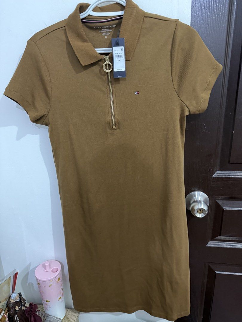 Tommy Hilfiger Polo Dress (Category: Dresses) located in Taguig. Submitted by prettymaistuff (Listing ID 1437338058, Image 2). Description: - Tommy Hilfiger polo dress - 💯 Authentic from Canada - Size: M (Fits up to Large Frame) stretchable - Features: Collared neckline, short sleeves, zip-up front - Color: Brown - Design: Tommy Hilfiger logo on chest - Material: 100% cotton - w/ tag price $99.50 (P6,048.00) - Mall Price P5,000- P6,000.00 -Bough