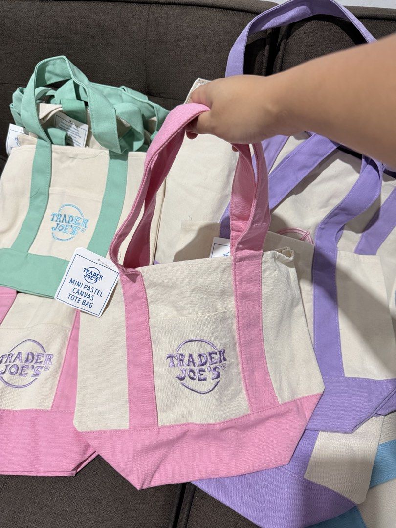 Trader Joe's Mini Pastel Canvas Tote Bag (Category: Tote Bags) located in Cagayan de Oro. Submitted by kierzy (Listing ID 1437353986, Image 2). Description: - Trader Joe's mini tote bags - Pastel colors: pink, purple, mint green, light blue - Canvas material - Colored accents on bottom and handles - Small front pocket - Perfect for small items and accessories.