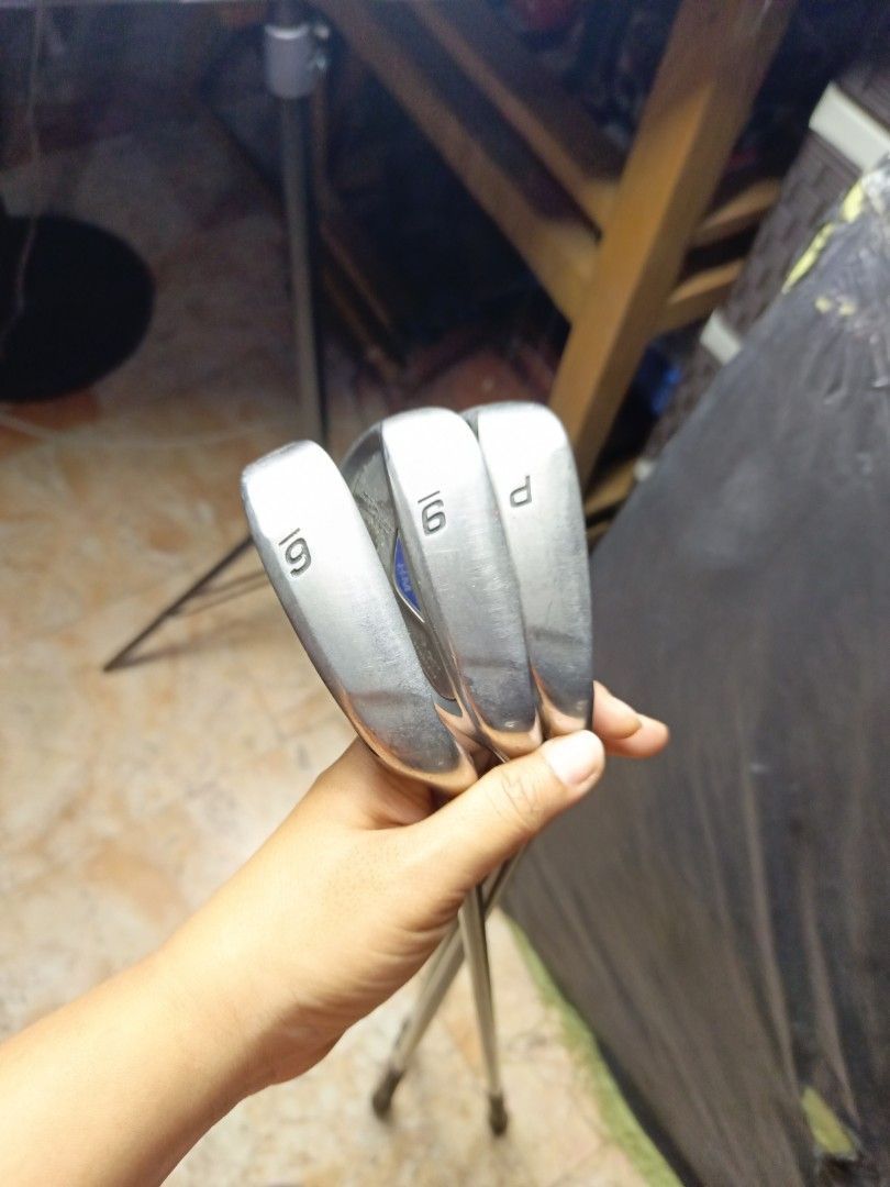 Tsuruya axel hm iron for practice (Category: Golf) located in Manila. Submitted by yeonmei5614747 (Listing ID 1437218454, Image 2). Description: - Golf club set includes6 & 9 iron and pitching wedge. - Features black shafts with silver and blue accents. - Club heads are silver with a blue and white design. - Grips are black and textured..
