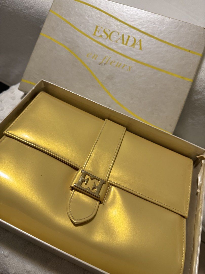 Vintage Escada Clutch Purse (Category: Luxury Bags & Wallets) located in Quezon City. Submitted by prelovedbyaisc (Listing ID 1437265576, Image 2). Description: - Escada yellow handbag - Includes original box - Flap closure .