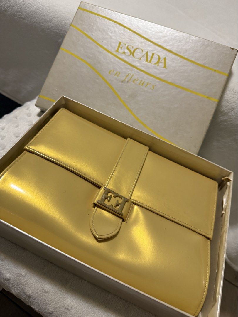 Vintage Escada Clutch Purse (Category: Luxury Bags & Wallets) located in Quezon City. Submitted by prelovedbyaisc (Listing ID 1437265576, Image 1). Description: - Escada yellow handbag - Includes original box - Flap closure .