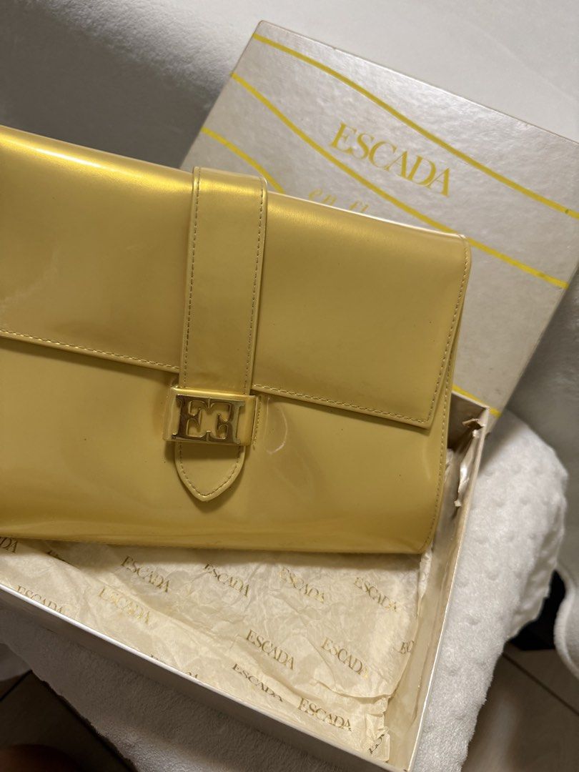 Vintage Escada Clutch Purse (Category: Luxury Bags & Wallets) located in Quezon City. Submitted by prelovedbyaisc (Listing ID 1437265576, Image 3). Description: - Escada yellow handbag - Includes original box - Flap closure .